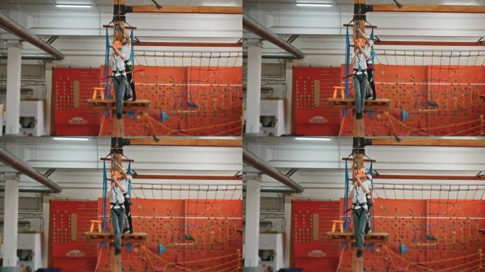 一个勇敢的10岁男孩在绳索公园里沿着一根细绳子走