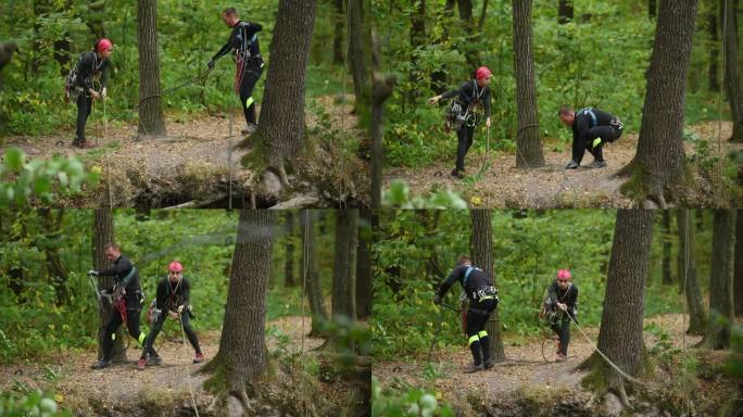 两个登山者，男孩和女孩，带着他们的装备在岩石山的森林里。两根扔出悬崖的安全绳。