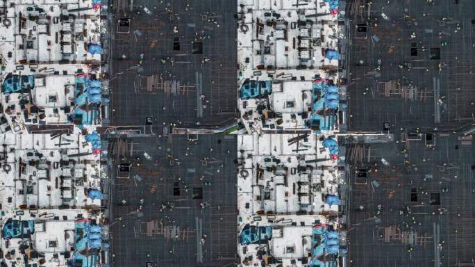 在建筑工地工作的工人的T/L无人机视角