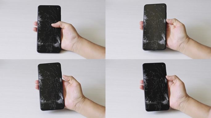 手上屏幕破碎的智能手机