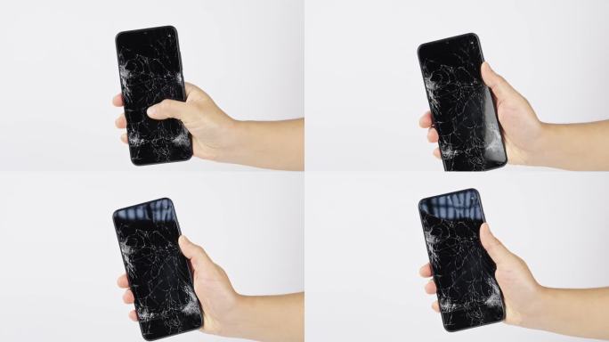 手上屏幕破碎的智能手机
