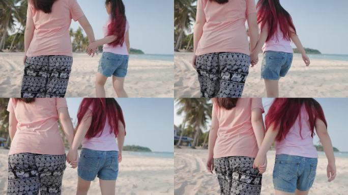 一对深情的姐妹在度假期间漫步在阳光明媚的海滩上。