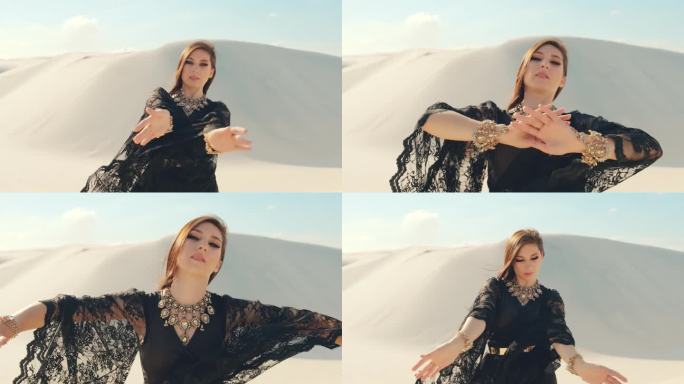 穿着黑裙子跳舞的漂亮女人。阿拉伯背景，沙漠，自然沙丘沙
