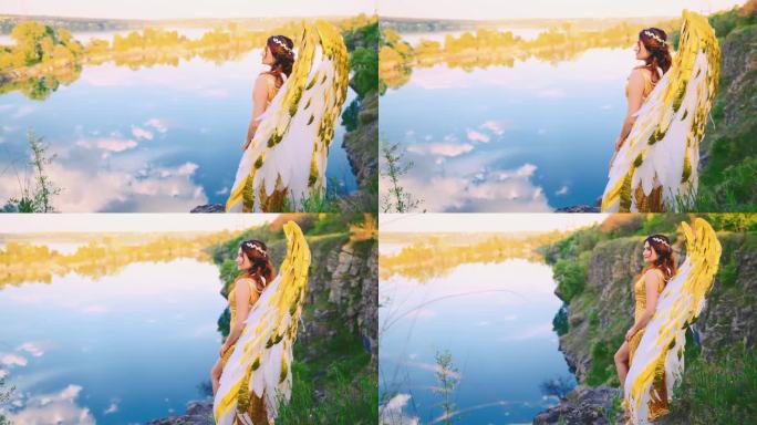 快乐幻想的女人天使与金白色的翅膀走在山顶神奇的蓝天绿草丘陵。希腊女神。仙女女王，性感仙女。夏季自然湖