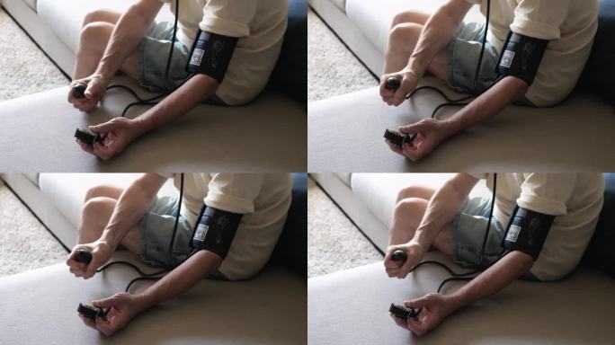 高级白人男子在家里测量血压