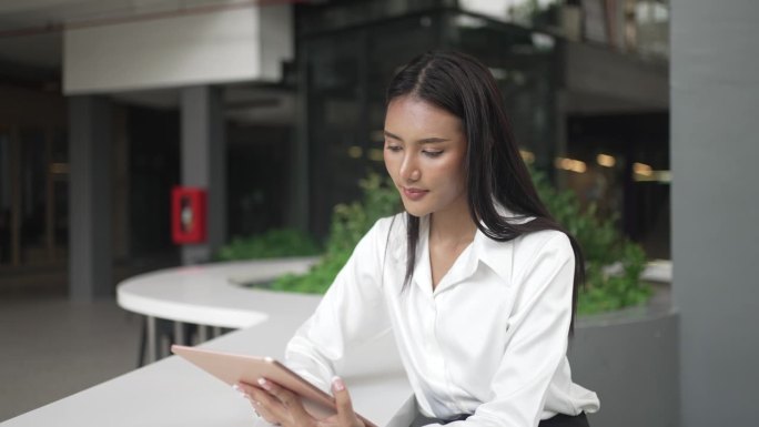 年轻女子在公共场所使用电子设备。