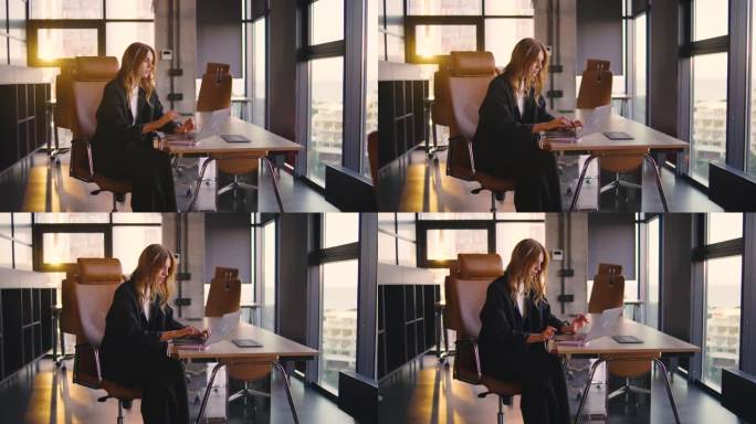 一位穿着休闲职业装的年轻专业人士在现代办公室里用一台光滑的笔记本电脑工作，捕捉着象征着创新和高生产力