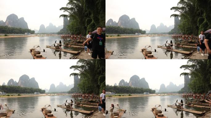 桂林阳朔漓江岸边拍照的游客