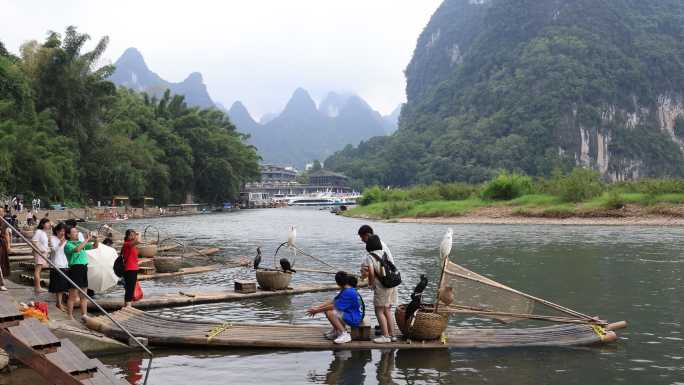 桂林阳朔漓江岸边拍照的游客