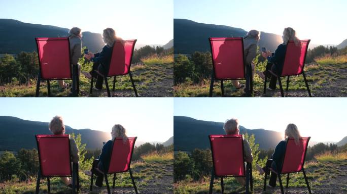 日出时，一对成熟的夫妇在椅子上放松