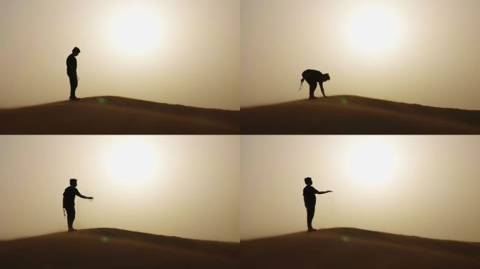 男人沙漠中行走 抓起沙子 沙漠人物剪影
