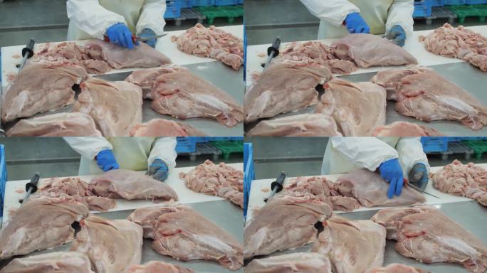 工厂里的工人正在切一块肉