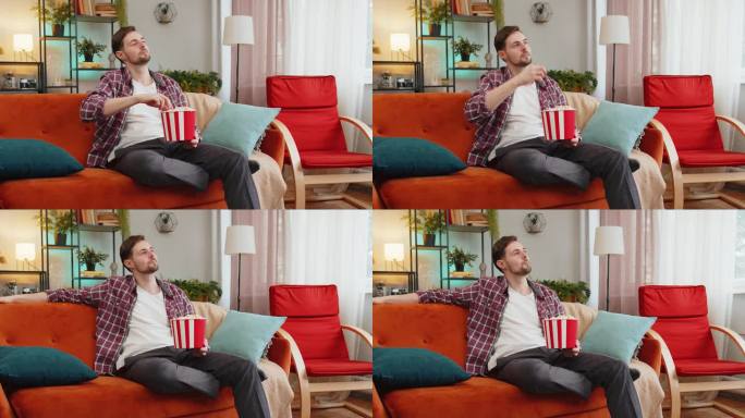 一个快乐的人坐在家里的沙发上吃着爆米花，看着有趣的电视连续剧，体育游戏，网络电影