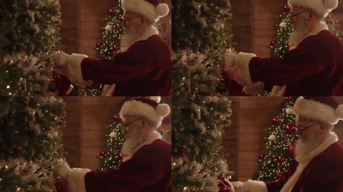 打扮成圣诞老人的老人在挂袜子和装饰品