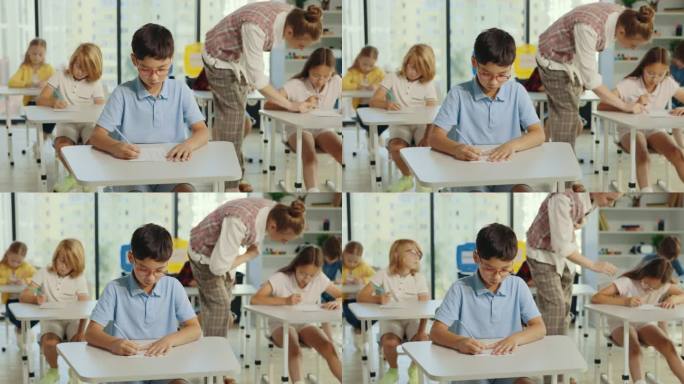 戴着眼镜的亚裔男生坐在教室的第一张桌子前填写试卷，老师在后台帮助学生答题。人与教育理念