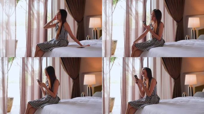 休闲迷人的年轻亚洲女性使用智能手机，躺在床上，在早晨舒适舒适的社交媒体通信surt生活方式在当代家居