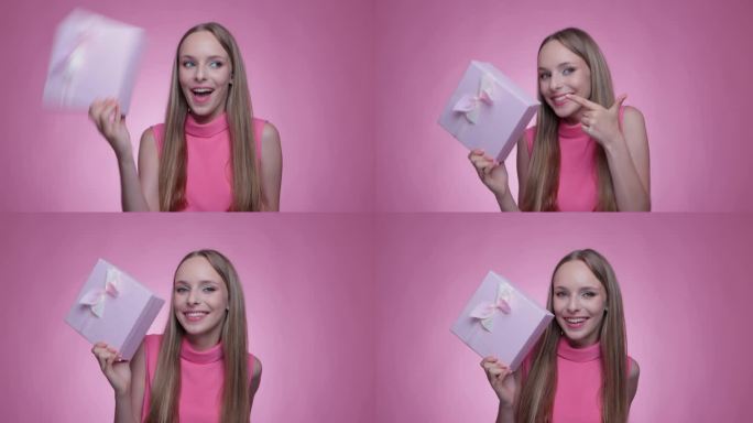 一个美丽的微笑的女孩收到了一个粉红色的盒子里的礼物，并打开了它。