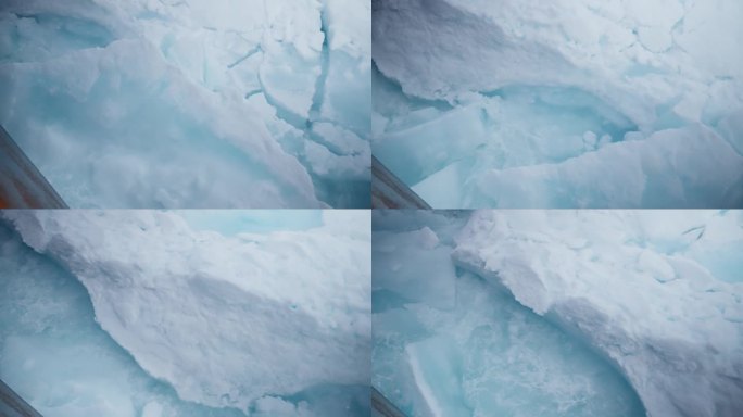 一艘船在北极的北冰洋上航行，在冰封的风景中展示了大自然的美丽和力量