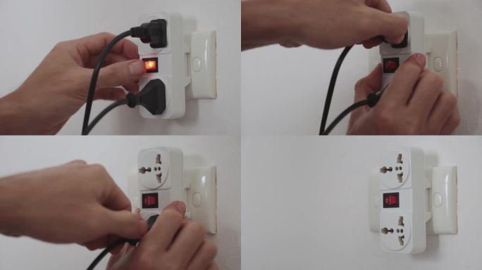 人的手拔掉电器插头与2节适配器插头转换器