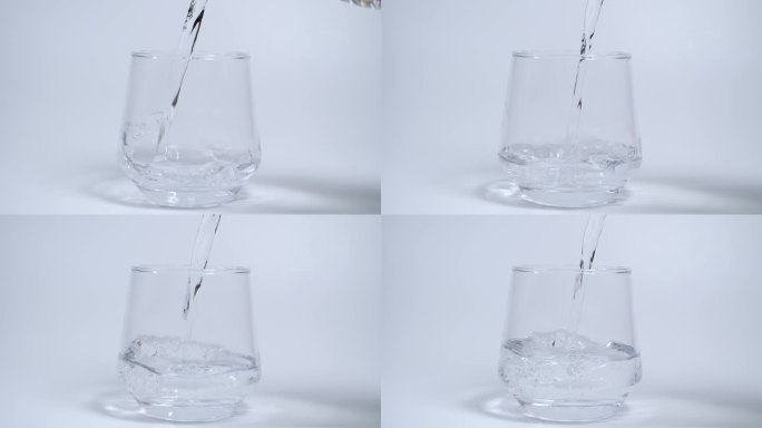 把水倒进白色背景的空杯子里