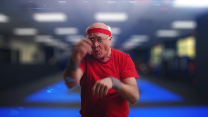幽默的爷爷穿着运动服在健身房练习空手道动作，武术