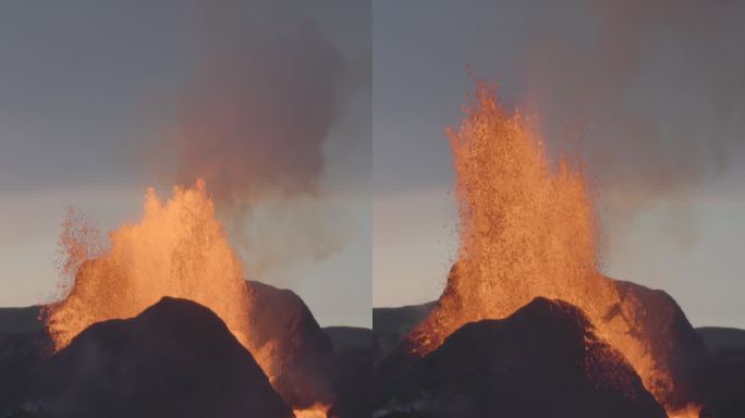 强大的火山喷发熔岩喷泉黄昏冰岛垂直