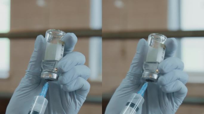 匿名兽医的手在注射器中注入药物并排出空气