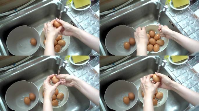 亚洲妇女在水中清洗一个新鲜的生鸡蛋。