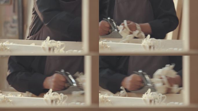 老木匠正在用刨木机刨木头