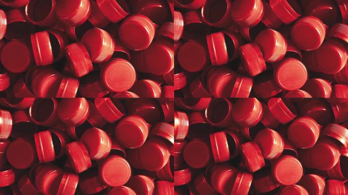 塑料瓶盖。以回收收集和生产加工塑料瓶盖为背景，工业生产红色高密度聚乙烯瓶盖。
