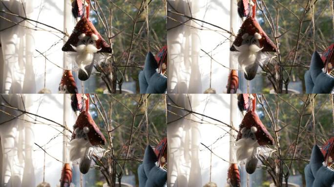 孩子们正在制作挂在窗户前树枝上的小精灵