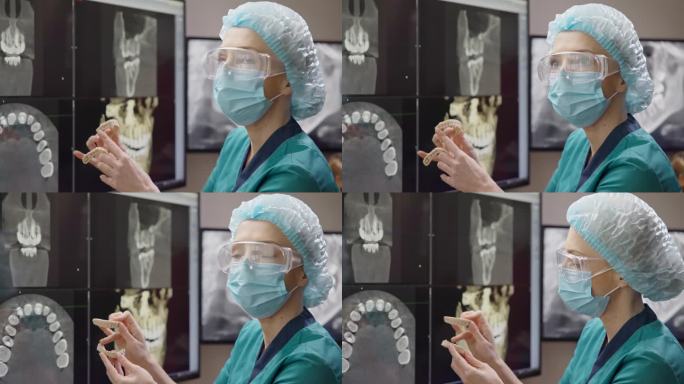 骨科牙医医生在x射线背景下拿着牙齿3d打印的病人颌骨模型