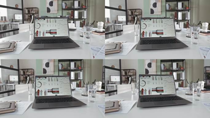 无线笔记本电脑的图表和图表在屏幕上的办公桌