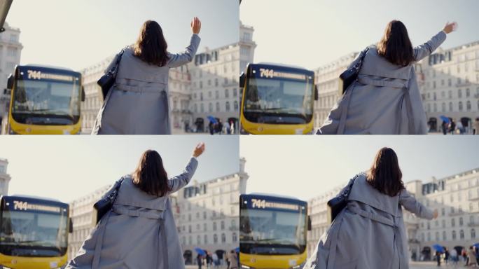 白天在熙熙攘攘的城市广场打车的妇女