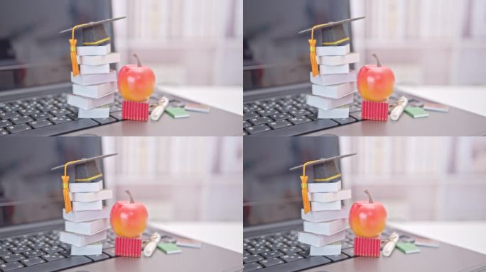 研究生出国留学项目拓宽学习者的世界观，电子学习理念:毕业帽，一个苹果，笔记本电脑上的外文书籍。试图远