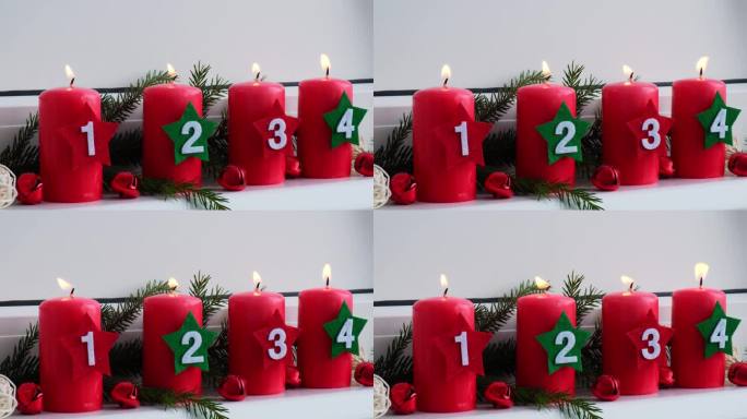 新年和圣诞节的准备。四支红色降临节蜡烛，白色窗台上有数字。手工环保装饰。可持续的圣诞装饰