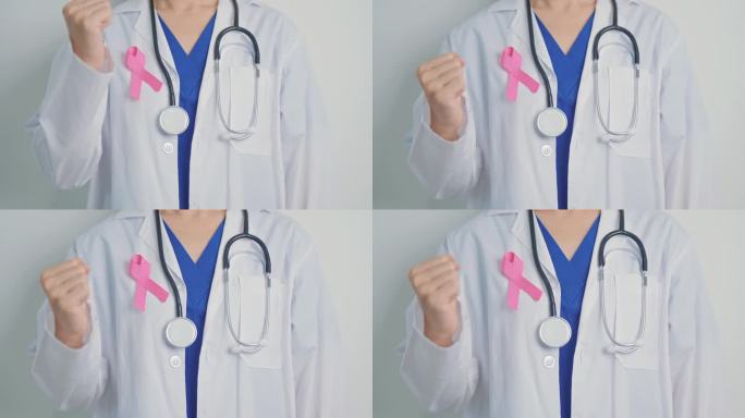 粉红十月乳腺癌宣传月，带着粉红丝带的女医生在医院支持人们的生命和疾病。全国癌症幸存者月，母亲和世界癌