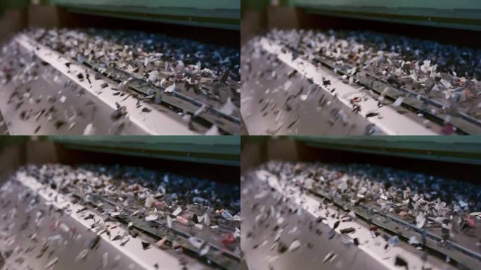工厂里的回收机器嗡嗡作响，小块的材料飞了出来