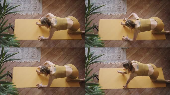 运动女性使用智能手机进行在线伸展运动的俯视图