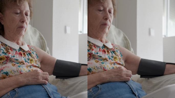 老妇人在家里测量血压