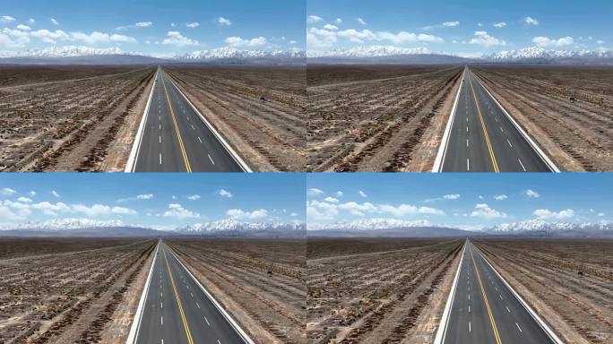 航拍甘肃祁连山雪峰下的公路