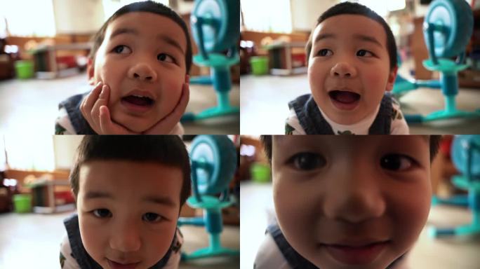 小朋友趴在地上对着镜头发呆