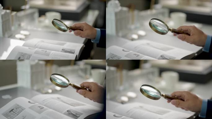 学者用放大镜看书阅览学习看书认真