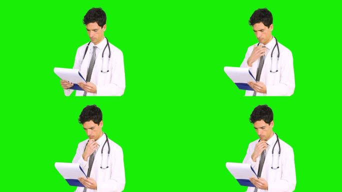 医生在绿色背景下阅读病历。