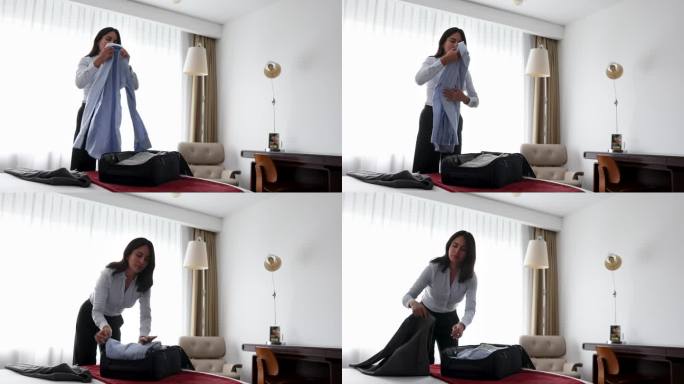 酒店里的女商人正在收拾行李，准备退房。