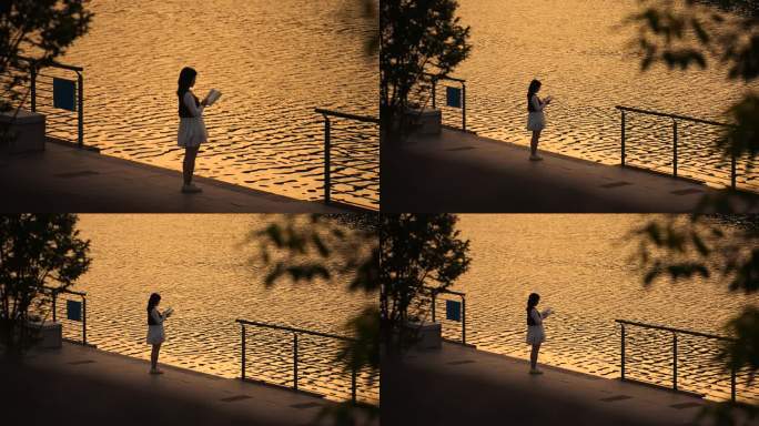 夕阳下女生在河边看书意境