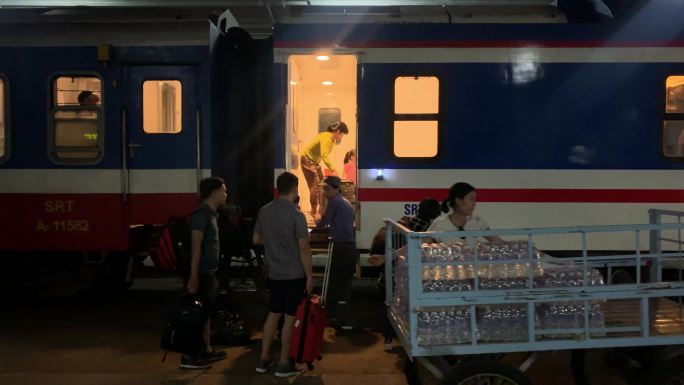 越南火车站内站台月台准备行驶的火车和游客