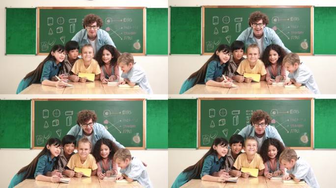 白人教师和多元化学生在教室里看着镜头。教育学。