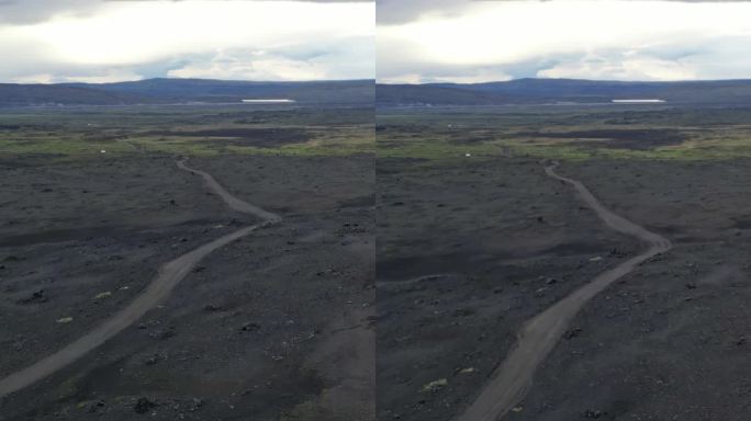 汽车在冰岛阳光明媚的荒凉灰色火山景观的高速公路上行驶。暑假。远处的山丘。