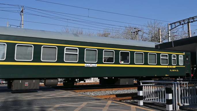 绿皮火车快速驶过铁路道口